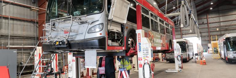 Bus on a lift at 1399 Marin St.
