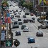 8th Street before: three travel lanes, cyclist riding in a bike lane, a car is traveling across the bike lane.