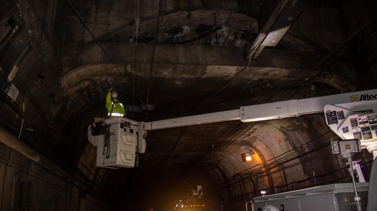 A worker inspects infrastructure in the Twin Peaks Tunnel A worker inspects infrastructure in the Twin Peaks Tunnel