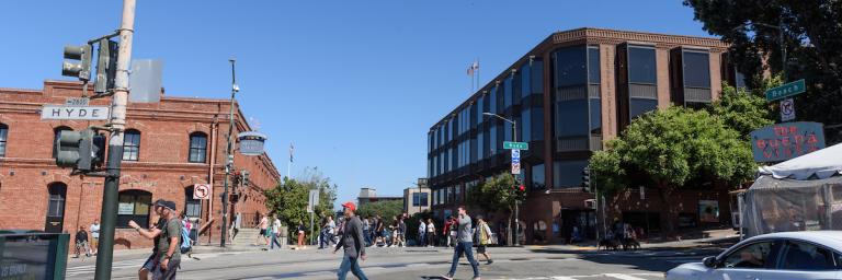 people walking across Beach Street