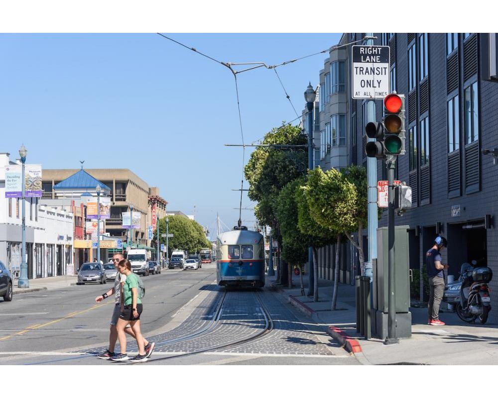 F line on Beach at Jones, pedestrians crossing the tracks