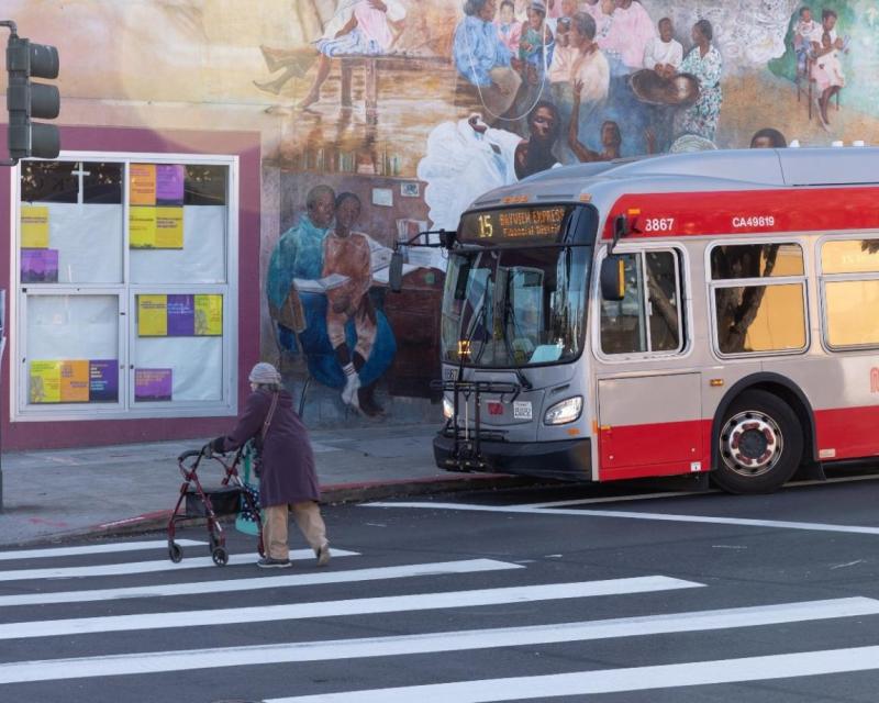 The 15 Bayview Hunters Point Express waits for person crossing the street. 
