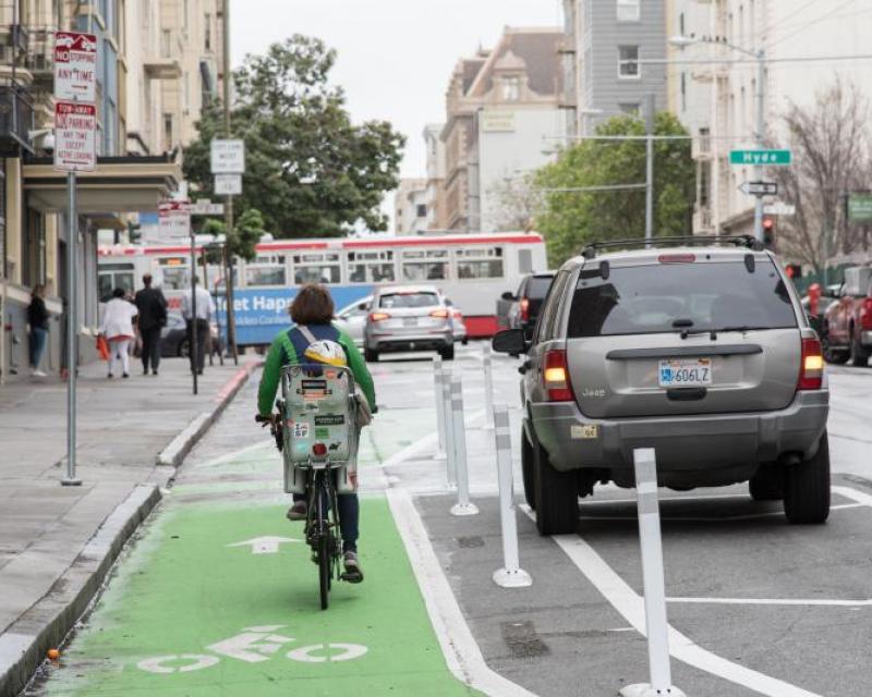 A person riding a bike on the newly reconfigured Turk Street