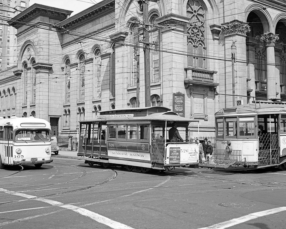 A unique sight: a Muni bus, a cable car, and streetcar, all posed together at the corner of Jackson Street and Fillmore in 1948.
